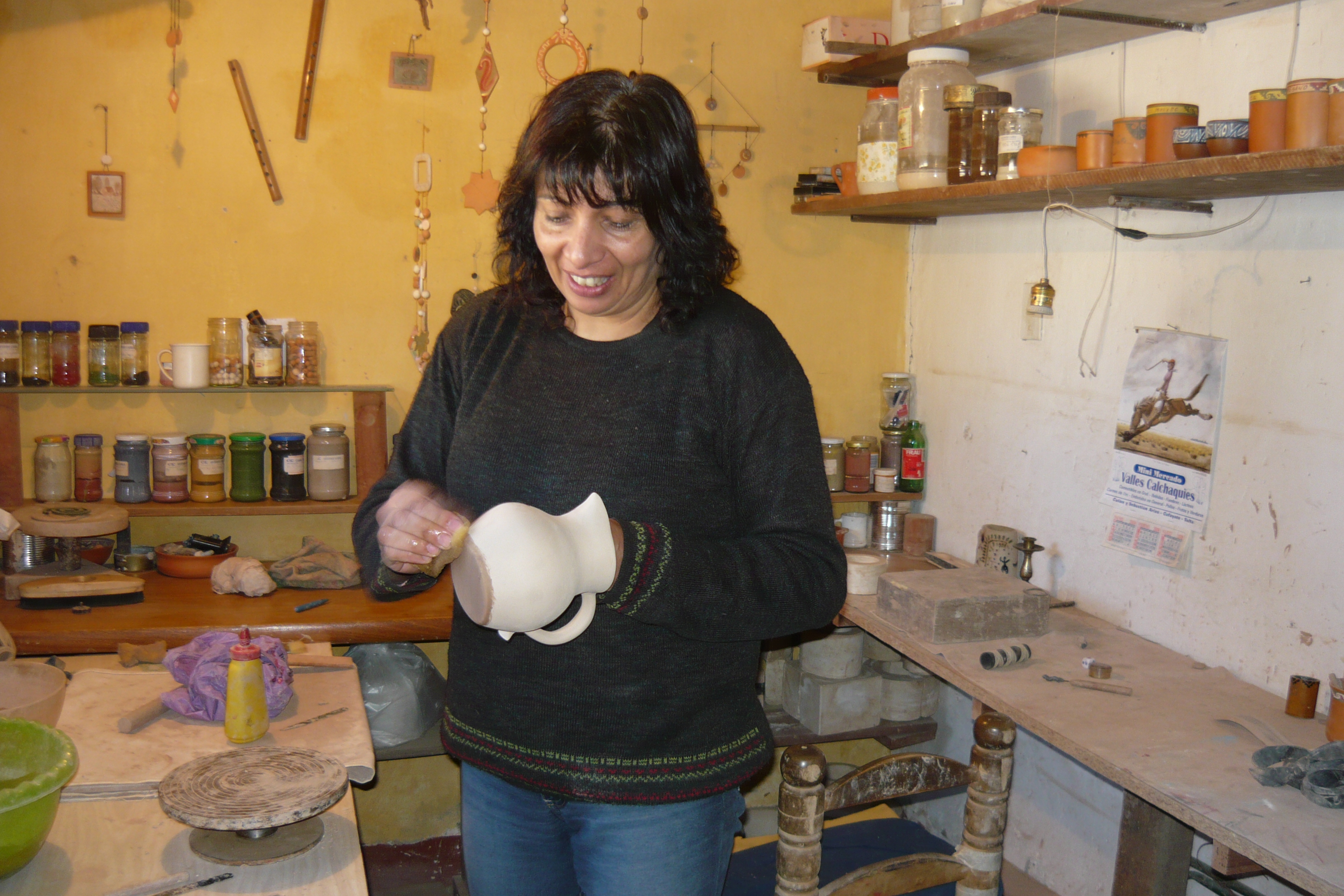 Artesana trabajando una pieza de cerámica en su taller